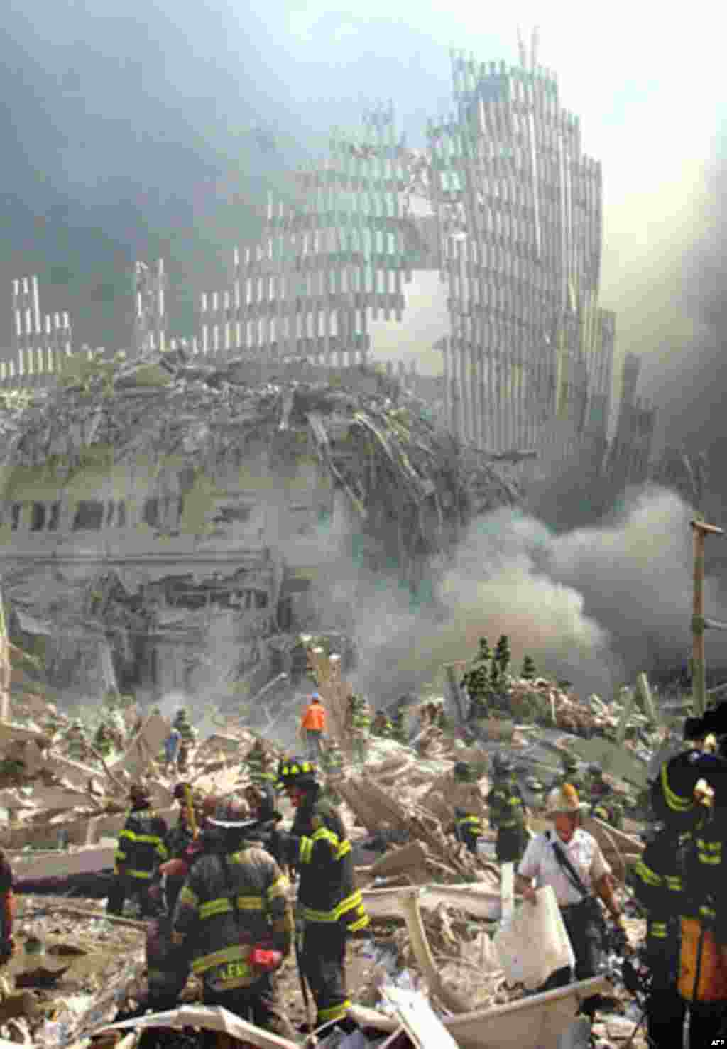 A shell of what was once part of the facade of one of the twin towers of New York's World Trade Center rises above the rubble that remains after both towers were destroyed in a terrorist attack Tuesday, Sept. 11, 2001. The 110-story towers collapsed after