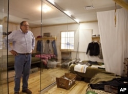 Steve Leger, executive director of the Heart Mountain Interpretive Learning Center, stands in a replica of a lived-in barracks room.
