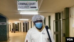  Journalist Hopewell Chin'ono arrives at the Harare Magistrate’s Court on Jan. 9, 2021, in full personal protective equipment (PPE), complaining about his continued 'persecution.' (Columbus Mavhunga/VOA) 