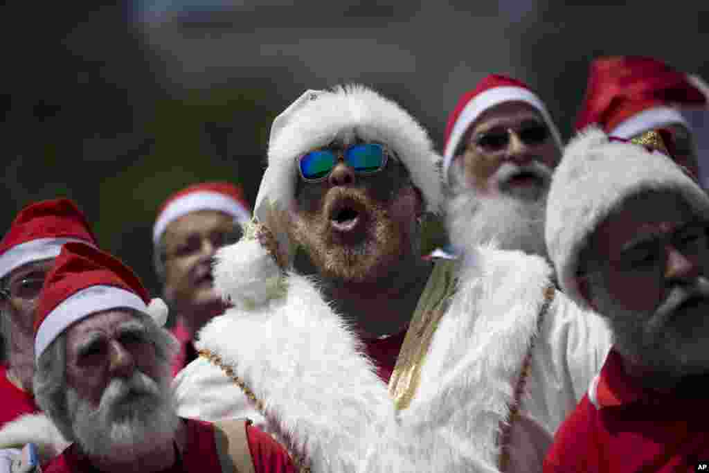 Recent graduates of a Santa school sing Christmas carols during their graduation ceremony in Rio de Janeiro, Brazil. The &quot;Escola de Papai Noel do Brasil&quot; graduated dozens of students who are now ready to be hired to play the part of Kriss Kringle during the Christmas season.