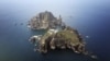 A set of remote islands called Dokdo in Korean and Takeshima in Japanese is seen in this picture taken from a helicopter August 10, 2012. 