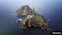 A set of remote islands called Dokdo in Korean and Takeshima in Japanese is seen in this picture taken from a helicopter August 10, 2012. 