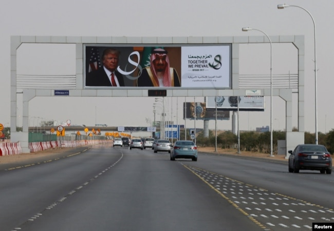 U.S. President Donald Trump's and Saudi Arabia's King's Salman bin Abdulaziz Al Saud's photos are seen with flags of both countries on airport road as part of celebrations to welcome United States President Donald Trump, in Riyadh, Saudi Arabia, May 19, 2