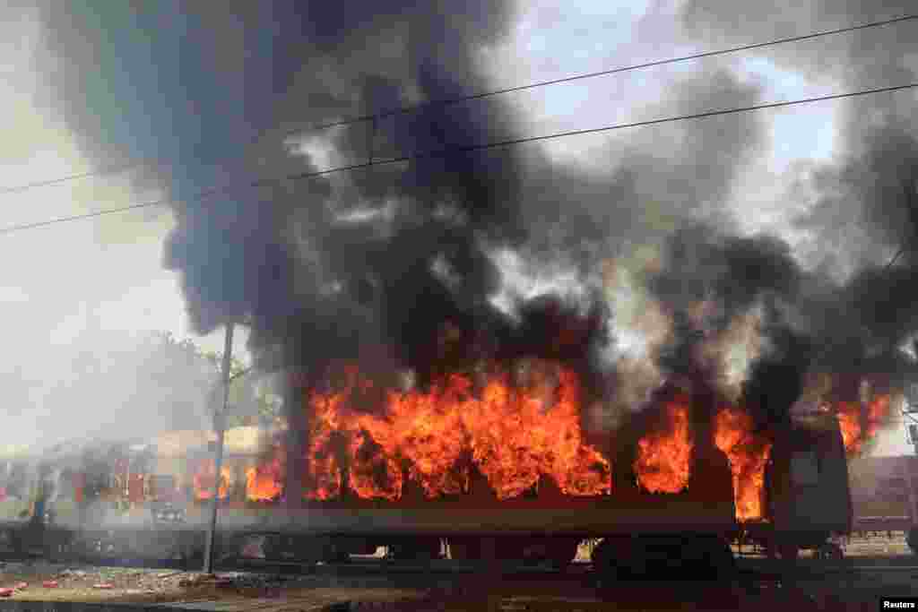 Smoke and fire billows out from a coach of a passenger train after it caught fire near Birlanagar railway station in Gwalior, India.