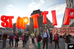 Protesters hold an anti-TTIP inflatable banner during a demonstration against international trade agreements in Brussels, Sept. 20, 2016.