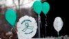 FILE - Balloons are displayed outside a doctor's office on the first anniversary of the Sandy Hook massacre, in Newtown, Connecticut, Dec. 14, 2013. 
