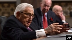 Former U.S. secretary of state Henry Kissinger (L) speaks during the Senate Armed Services Committee hearing on Capitol Hill in Washington, Jan. 25, 2018, on global challenges and U.S. national security strategy.