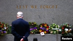 A veteran looks at floral tributes and wreaths that have been laid at the Cenotaph before the start of the annual ANZAC (Australian and New Zealand Army Corps) Day march through central Sydney, Australia, April 25, 2017.