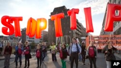 Protesters hold an anti-TTIP inflatable banner during a demonstration against international trade agreements in Brussels, Sept. 20, 2016.