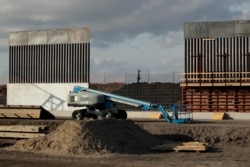 The first panels of levee border wall are seen at a construction site along the U.S.-Mexico border, Thursday, Nov. 7, 2019, in Donna, Texas. The new section, with 18-foot tall steel bollards atop a concrete wall, will stretch approximately 8 miles.