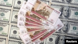 A picture illustration shows U.S. dollar and Russian ruble banknotes in Sarajevo, March 9, 2015. 