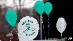 FILE - Balloons are displayed outside a doctor's office on the first anniversary of the Sandy Hook massacre, in Newtown, Connecticut, Dec. 14, 2013. 