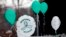 FILE - Balloons are displayed outside a doctor's office on the first anniversary of the Sandy Hook massacre, in Newtown, Connecticut, Dec. 14, 2013. 