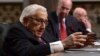 Former U.S. secretary of state Henry Kissinger (L) speaks during the Senate Armed Services Committee hearing on Capitol Hill in Washington, Jan. 25, 2018, on global challenges and U.S. national security strategy.