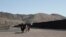 Border Patrol agents on horseback ride along a US-Mexico border fence on Jan. 31, 2020, in nearby town of Sunland Park, New Mexico.