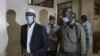 Mohamed Ahmed Abdi, left, and Hassan Hussein Mustafa, center, are escorted away after being sentenced for their involvement in the Westgate Mall attack of Sept. 2013, in Nairobi, on Oct. 30, 2020.