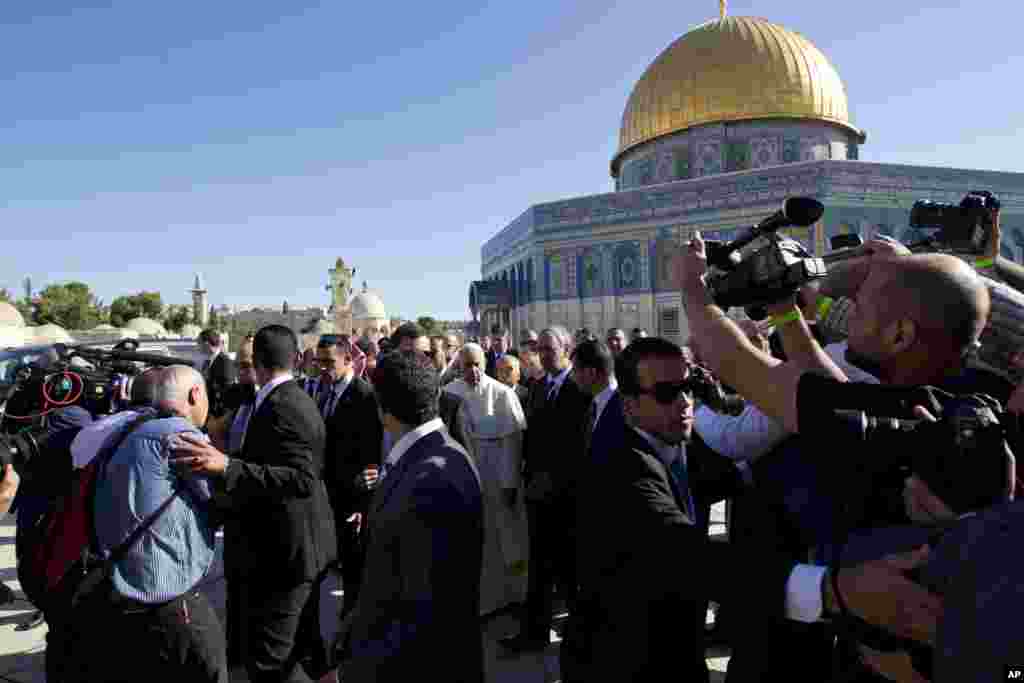 Pope Francis is surrounded by journalists near the Dome of the Rock Mosque, May 26, 2014.