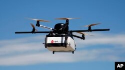 FILE - GeoPost, a package delivery subsidiary of LaPoste, tested this prototype drone carrying a parcel in Pourrieres, southern France, June 23, 2015.