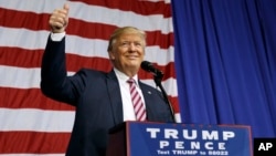 Republican presidential candidate Donald Trump gestures as he arrives to speak at a campaign rally at the Delaware County Fair, Oct. 20, 2016, in Delaware, Ohio. 