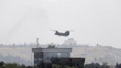 A U.S. Chinook helicopter flies near the U.S. Embassy in Kabul, Afghanistan, Sunday, Aug. 15, 2021.