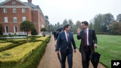 Britain's Foreign Secretary Jeremy Hunt walks with Slovakian Europe Minister Frantisek Ruzickas, left, during a walk in the grounds of Chevening House, in Sevenoaks, England, Sunday, Oct. 14, 2018. Hunt played host to Eastern European Foreign Ministers at his official country residence ahead of a meeting on Monday at the Foreign Affairs Council in Luxembourg where chemical weapons sanctions will be formally adopted.