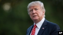 FILE - President Donald Trump walks from Marine One across the South Lawn of the White House in Washington, Aug. 23, 2017, as he returns from Reno, Nevada.