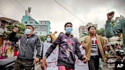 Protesters march through the streets during an anti-government demonstration in Mandalay, Myanmar, Dec. 7, 2021. (AP Photo, File)