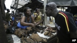 A man buys bush meat at a market in Yopougon, Abidjan, May 27, 2006.