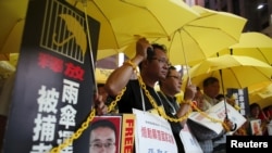 FILE - Pro-democracy protesters demanding the release of mainland activists take part in a rally in Hong Kong, China.