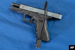 FILE - A Glock 17 pistol fitted a with a cablegram  benignant   weapon  fastener  successful  Philadelphia, May 10, 2023.