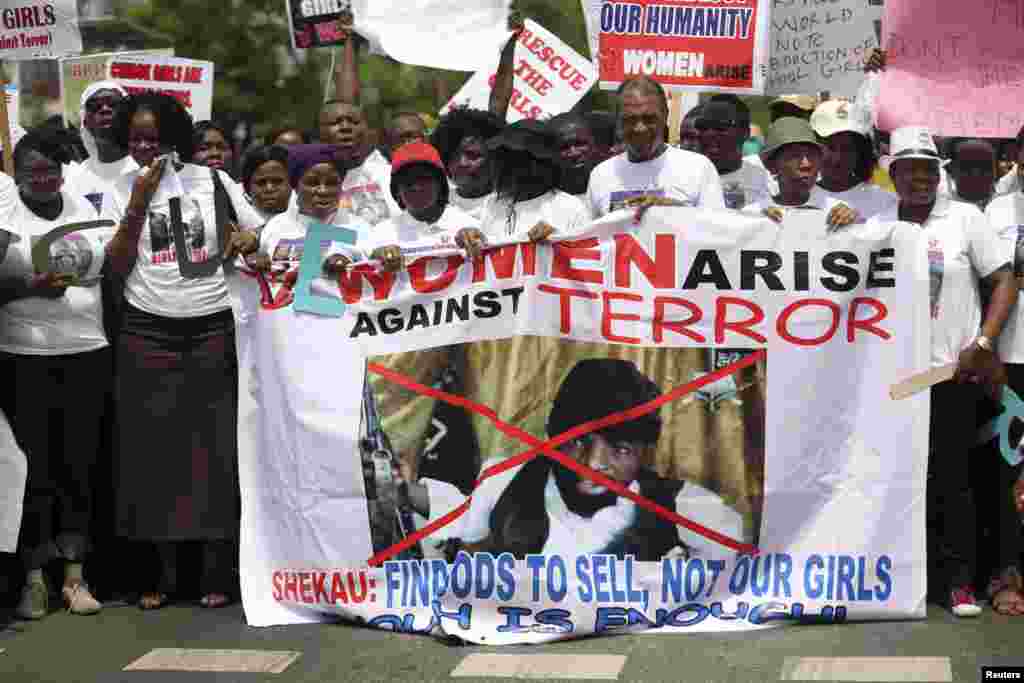 Demonstrators carry a banner with an image of Boko Haram leader Abubakar Shekau as they demand the release of the abducted schoolgirls, Lagos, Nigeria, May 12, 2014.