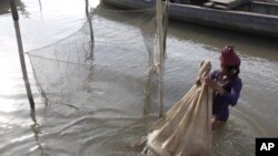 A Cambodian fisherman holds a bag loaded life fishes as his catches from the Mekong River at the out skirt of Phnom Penh, Cambodia, Tuesday, April 19, 2011. Laos has deferred decision on erecting in the first dam on the lower Mekong River in face of stron