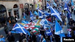 FILE - "All Under One Banner" pro-independence protesters take part in a march and rally in Edinburgh, Scotland, Oct. 6, 2018. 