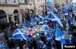 FILE - "All Under One Banner" pro-independence protesters take part in a march and rally in Edinburgh, Scotland, Oct. 6, 2018.