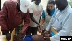 Health workers in Cameroon monitor the growth of infants and find that the growth of one-third of those children are stunted because of poor nutrition. (Courtesy UNICEF)