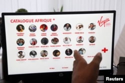 Franck-Alcide Kacou, Managing Director of Universal Music Africa and Virgin Music Label & Artist Services in Africa, displays the Virgin Music Africa's African catalog on a computer screen in his office in Abidjan, Ivory Coast June 29, 2022. (REUTERS/Luc Gnago)
