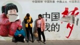 Passengers wait in front of a broken propaganda poster featuring "the China Dream" outside the Kunming Railway Station in Kunming, in western China's Yunnan province, Sunday, March 2, 2014.