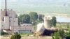 A North Korean nuclear plant is seen before demolishing a cooling tower (R) in Yongbyon, in this photo taken June 27, 2008 and released by Kyodo.