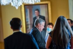 White House Chief of Staff Mark Meadows, center, waits in the office of Senate Majority Leader Mitch McConnell of Ky., on Capitol Hill in Washington, Aug. 3, 2020.