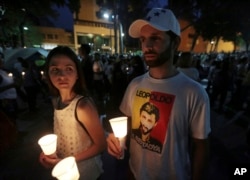 A student wearing a T-shirt with an image of jailed opposition leader Leopoldo Lopez attends a candlelight vigil for a slain classmate in Caracas, Venezuela, April 29, 2017.