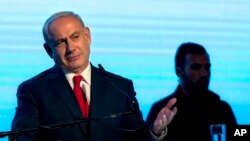 FILE - Israeli Prime Minister Benjamin Netanyahu gestures during a rally of his Likud party supporters, near Tel Aviv, Israel, Aug. 30, 2017. 