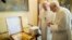 Pope Francis (L) exchanges a gift with Pope Emeritus Benedict XVI at the Castel Gandolfo summer residence, south of Rome, March 23, 2013.