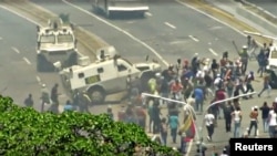 A Venezuelan National Guard (GNB) vehicle ploughs into opposition demonstrators in Caracas, Venezuela in this still image taken from a video footage Apr. 30, 2019.