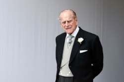 FILE - Britain's Prince Philip waits for the bridal procession following the wedding of Princess Eugenie of York and Jack Brooksbank at St George's Chapel in Windsor Castle, England.