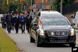 FILE - Mourners walk behind the hearse carrying the casket of Dr. Jerry Rabinowitz to Homewood Cemetery following a funeral service at the Jewish Community Center in the Squirrel Hill neighborhood of Pittsburgh, Oct. 30, 2018.