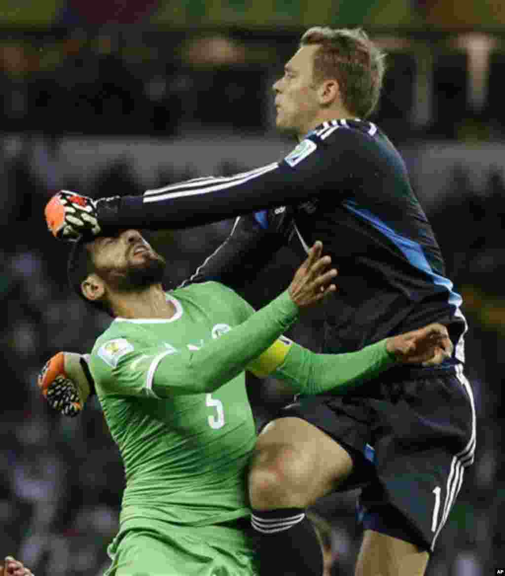 Germany's goalkeeper Manuel Neuer, right, hits Algeria's Rafik Halliche in the face after clearing the ball during the World Cup round of 16 soccer match between Germany and Algeria at the Estadio Beira-Rio in Porto Alegre, Brazil, Monday, June 30, 2014. 