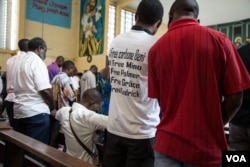 At a special church service to commemorate those who have died in pro-democracy demonstrations, a young man wears a t-shirt bearing the names of people still in detention. (C. Oduah/VOA)