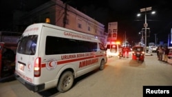 An ambulance is seen at the site of a blast at an ice-cream parlor in Mogadishu, Somalia, Nov. 27, 2020.