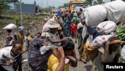 FILE - Congolese people flee from their villages around Sake in Masisi territory, following clashes between M23 rebels and the Armed Forces of the Democratic Republic of the Congo in North Kivu province, February 7, 2024.