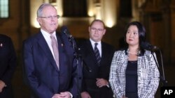 Peru's President Pedro Pablo Kuczynski, left,speaks as opposition leader and daughter of Peru's jailed former President Alberto Fujimori, Keiko Fujimori, right, looks on after their meeting at government palace in Lima, Peru, July, 11, 2017.